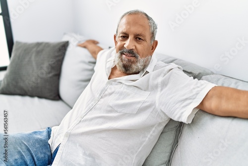 Senior grey-haired man smiling confident at home