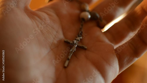 catholic prayer hold a rosary crucifix cross on the hand. spirital god cross.
