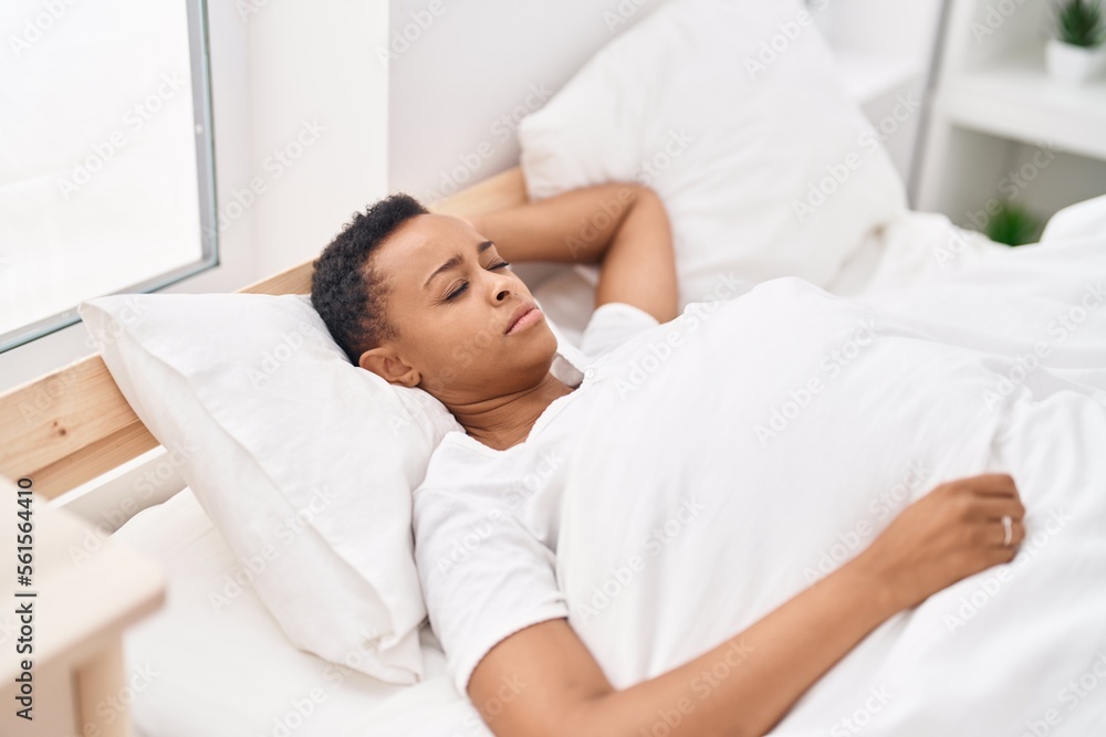 African american woman lying on bed sleeping at bedroom African american woman lying on bed sleeping at bedroom