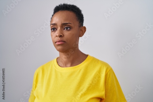 African american woman standing with serious expression over isolated white background