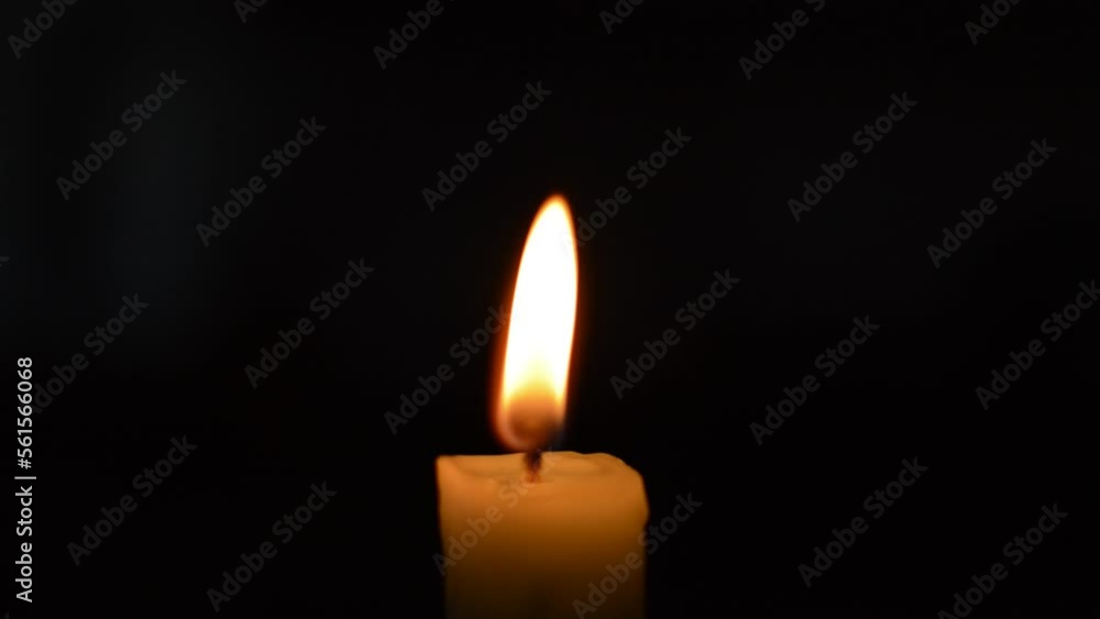 close-up red flame of a candle. candle burning in the dark background close-up red flame of a candle. candle burning in the dark background