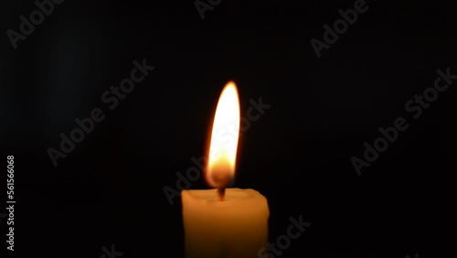 close-up red flame of a candle. candle burning in the dark background