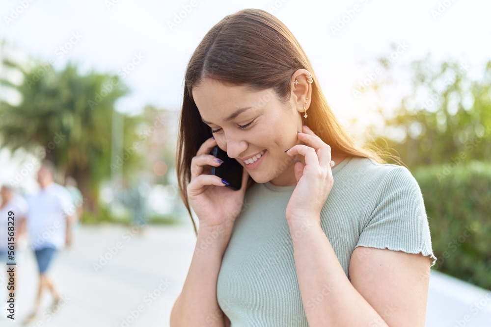 Young beautiful woman smiling confident talking on the smartphone at park Young beautiful woman smiling confident talking on the smartphone at park