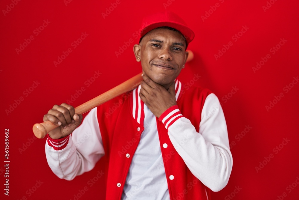 Young hispanic man playing baseball holding bat touching painful neck, sore throat for flu, clod and infection Young hispanic man playing baseball holding bat touching painful neck, sore throat for flu, clod and infection