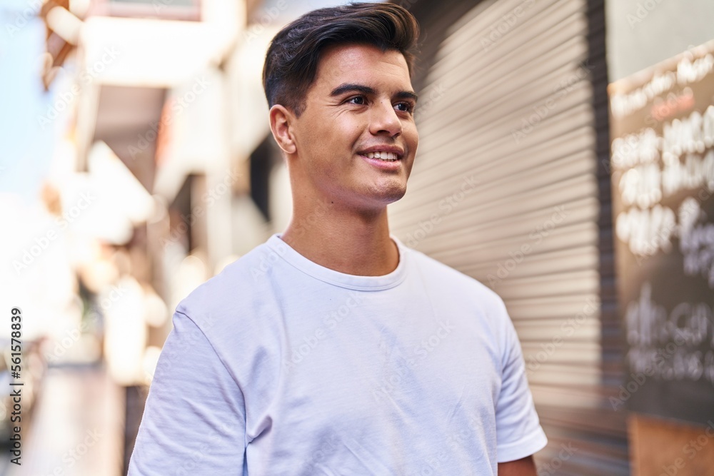 Fototapeta premium Young hispanic man smiling confident looking to the side at street