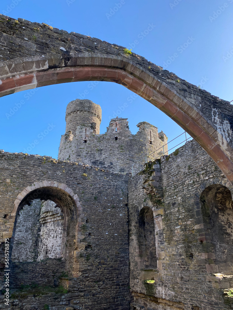 Conwy, North Wales, United Kingdom: Conwy Castle fortification built by Edward I, during his conquest of Wales. Arch framing the Bakehouse Tower. Great room and chapel in the interior of castle.