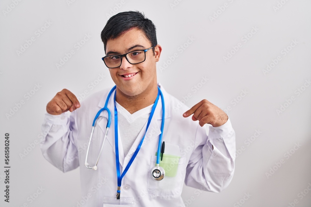 Young hispanic man with down syndrome wearing doctor uniform and stethoscope looking confident with smile on face, pointing oneself with fingers proud and happy. Young hispanic man with down syndrome wearing doctor uniform and stethoscope looking confident with smile on face, pointing oneself with fingers proud and happy.