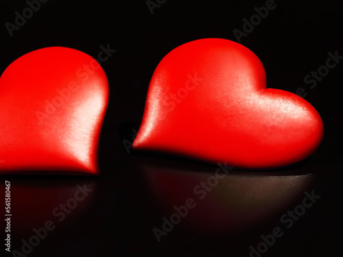 Pair of red hearts on a black background photo