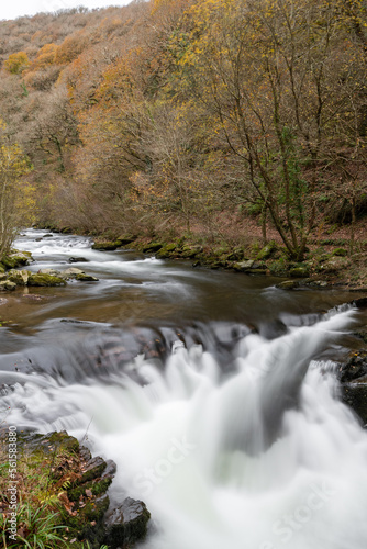 Fototapeta Naklejka Na Ścianę i Meble -  Long exposure of the Watersmeet Bridge waterfall at Watersmeet in Exmoor National Park