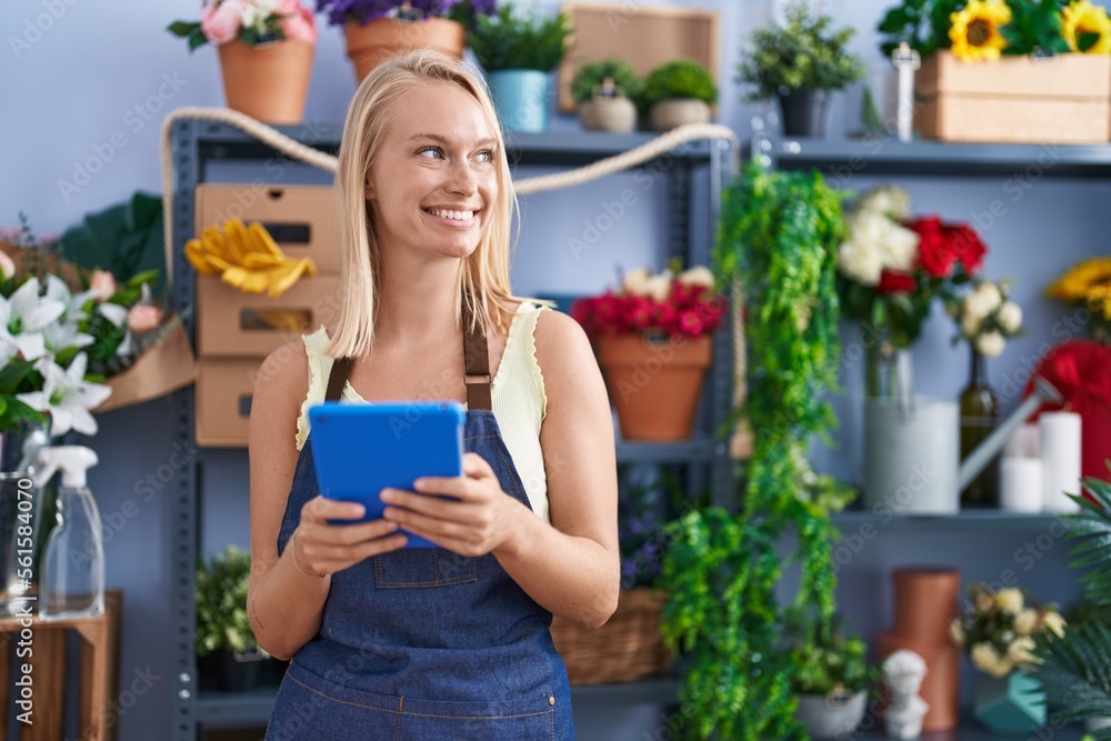 Young blonde woman florist smiling confident using touchpad at florist store Young blonde woman florist smiling confident using touchpad at florist store