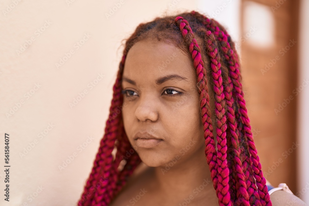 African american woman with relaxed expression standing at street