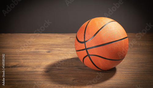Basketball ball on the wooden table. © andranik123