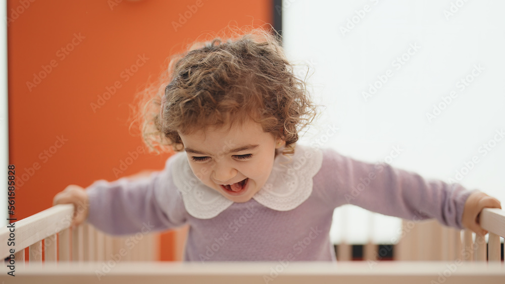 Adorable hispanic girl smiling confident standing on cradle at bedroom Adorable hispanic girl smiling confident standing on cradle at bedroom