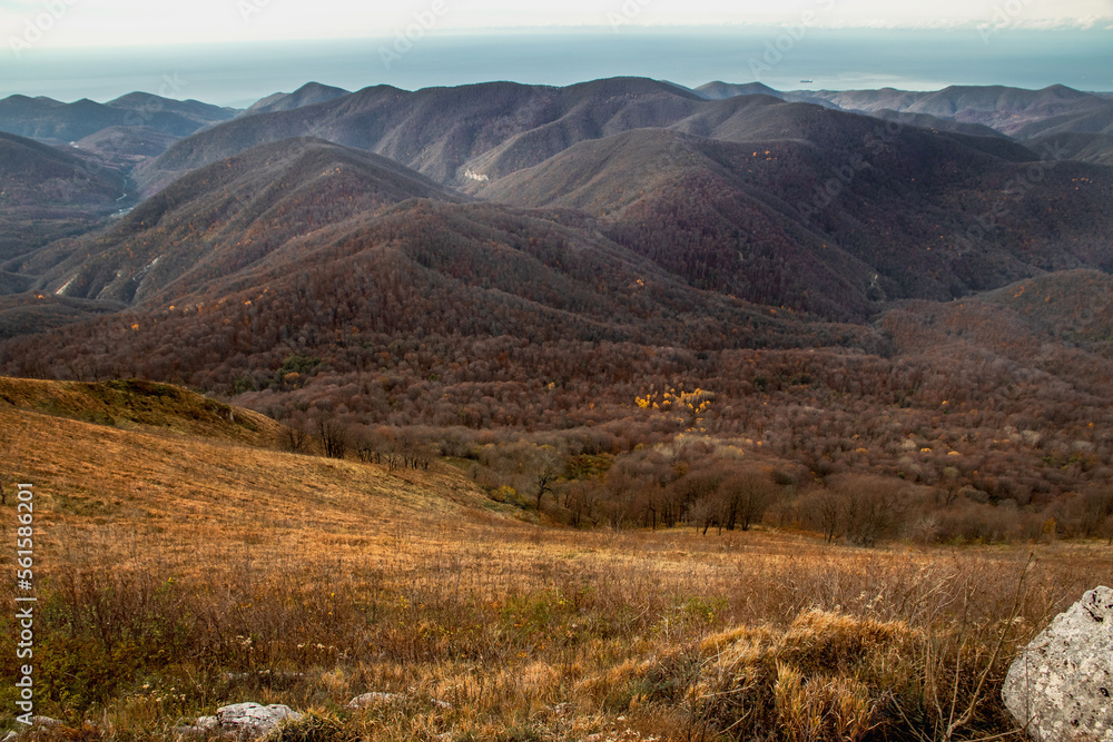 View from a height of 1000 m to the peaks of the North-Western Caucasus. Stunning view of the mountain landscape from a height. Stunning view from the top of Mount Peus.