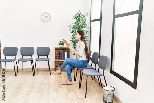 Young asian woman with checklist at waiting room