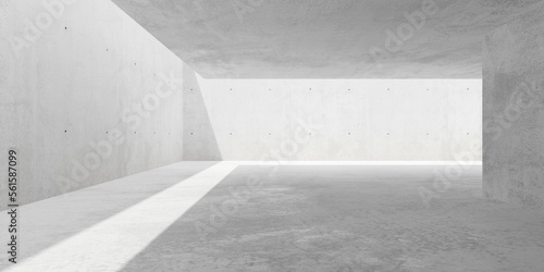Abstract large, empty, modern concrete room, sunlight from roof opening and rough floor - industrial interior background template