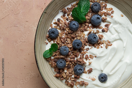 yogurt with chocolate muesli, with berries, blueberries, breakfast, close-up, fork on top, no people,