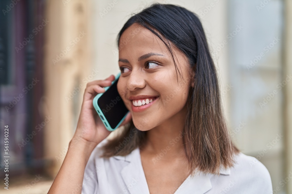 Young hispanic woman smiling confident talking on the smartphone at street Young hispanic woman smiling confident talking on the smartphone at street