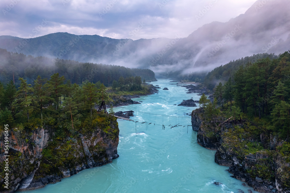 Evening landscape Altai mountains summer Russia, aerial top view. Blue Katun river with destroyed suspension bridge after flood, fog mood