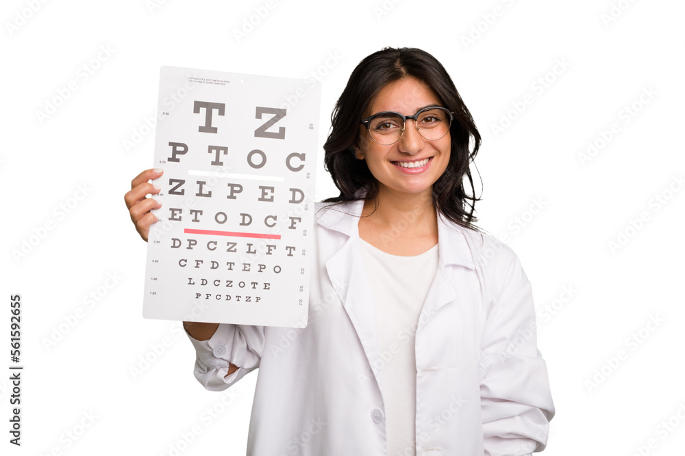 Young indian oculist woman holding an eye chart paper cut out isolated happy, smiling and cheerful. Young indian oculist woman holding an eye chart paper cut out isolated happy, smiling and cheerful.