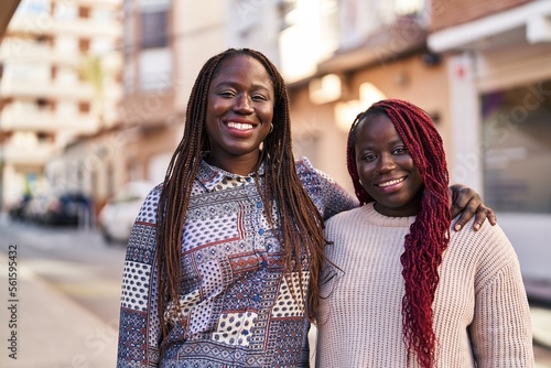African american women friends smiling confident hugging each other at street © Krakenimages.com