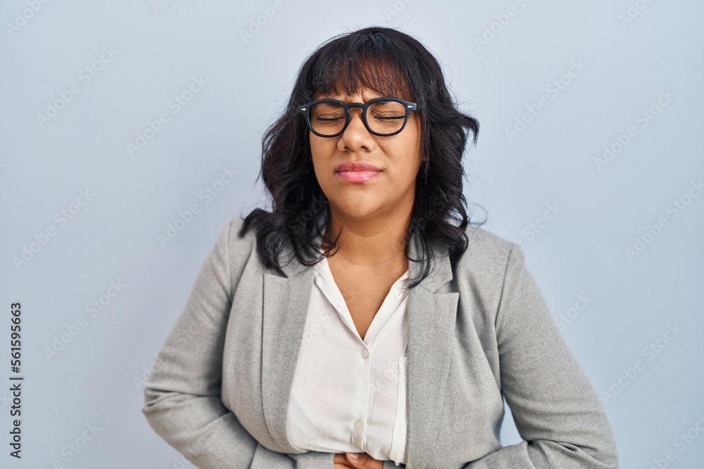 Hispanic woman standing over isolated background with hand on stomach because indigestion, painful illness feeling unwell. ache concept. Hispanic woman standing over isolated background with hand on stomach because indigestion, painful illness feeling unwell. ache concept.