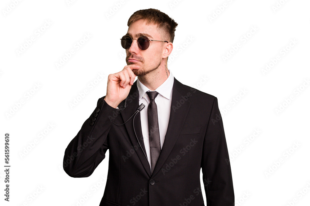 Security bodyguard man wearing a suit isolated cut out looking sideways with doubtful and skeptical expression.