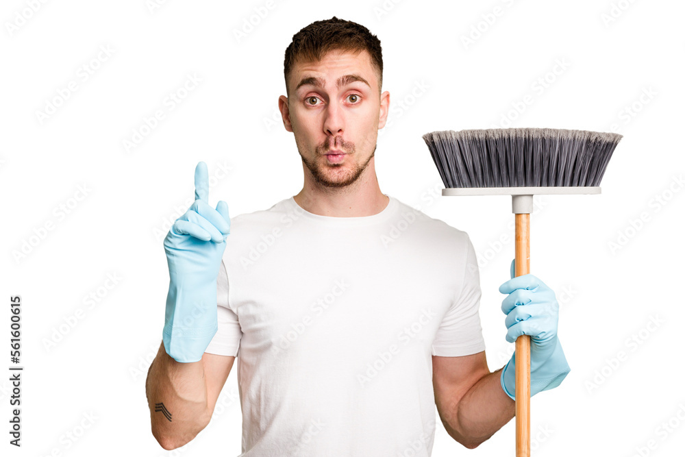 © Asier - Young man holding a broom to clean his house cut out isolated having some great idea, concept of creativity. © Asier - Young man holding a broom to clean his house cut out isolated having some great idea, concept of creativity.