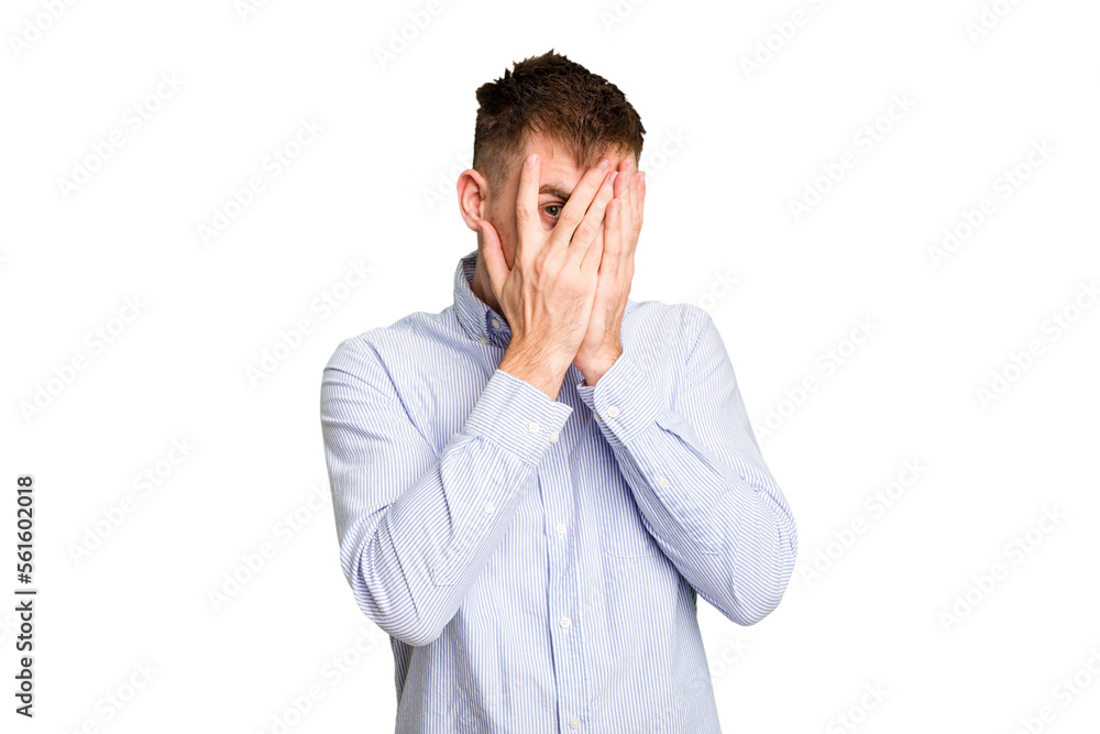 Young caucasian man cut out isolated blink through fingers frightened and nervous. Young caucasian man cut out isolated blink through fingers frightened and nervous.