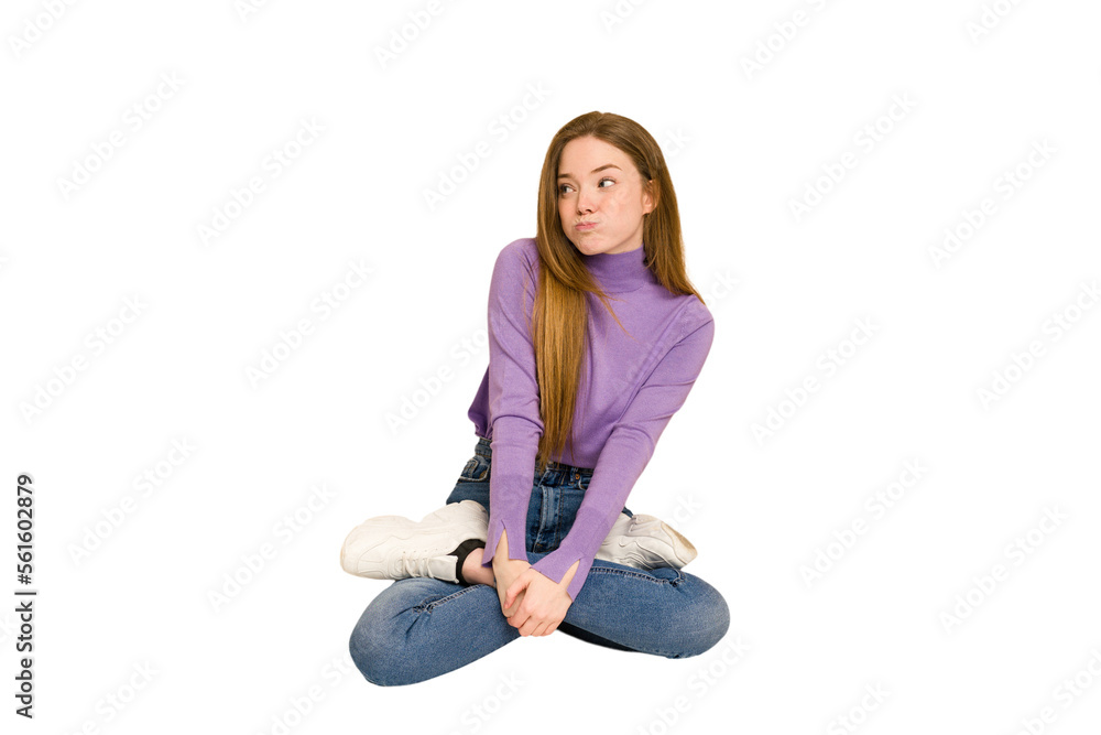 Young redhead woman sitting isolated cut out