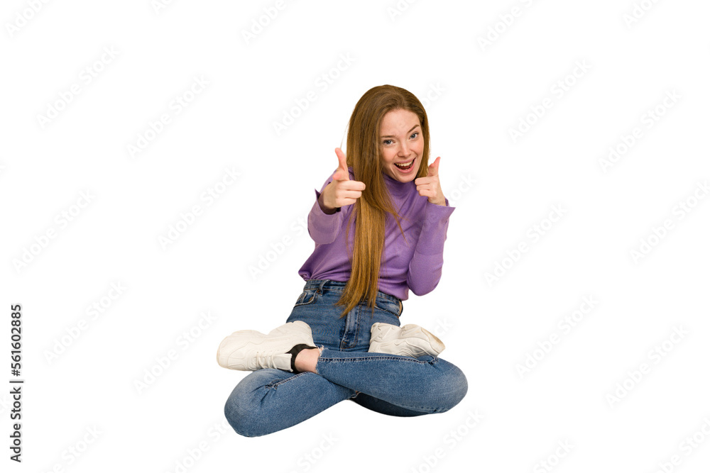 Young redhead woman sitting isolated cut out Young redhead woman sitting isolated cut out