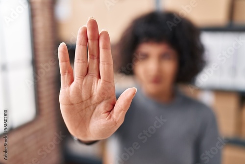 Young beautiful hispanic woman ecommerce business worker doing stop gesture with hand at office © Krakenimages.com