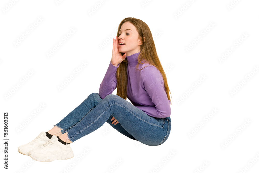 Young redhead woman sitting isolated cut out Young redhead woman sitting isolated cut out