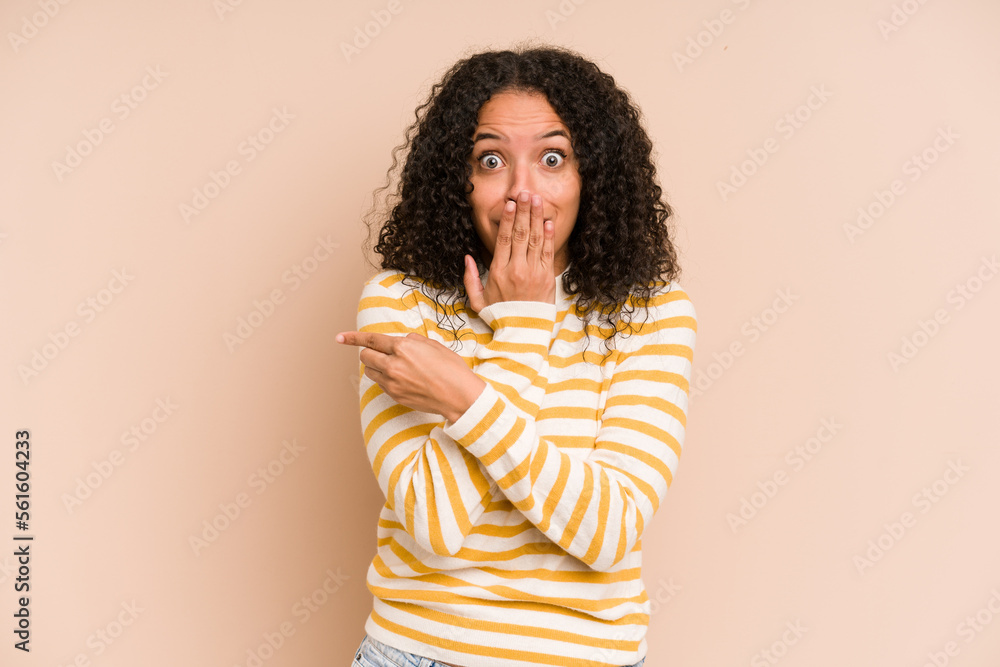 Young african american curly woman isolated pointing to the side Young african american curly woman isolated pointing to the side