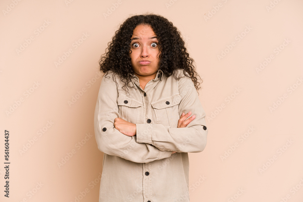 Young african american curly woman isolated blows cheeks, has tired expression. Facial expression concept. Young african american curly woman isolated blows cheeks, has tired expression. Facial expression concept.