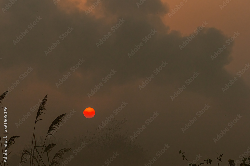 A rising Sun in a polluted atmosphere A rising Sun in a polluted atmosphere