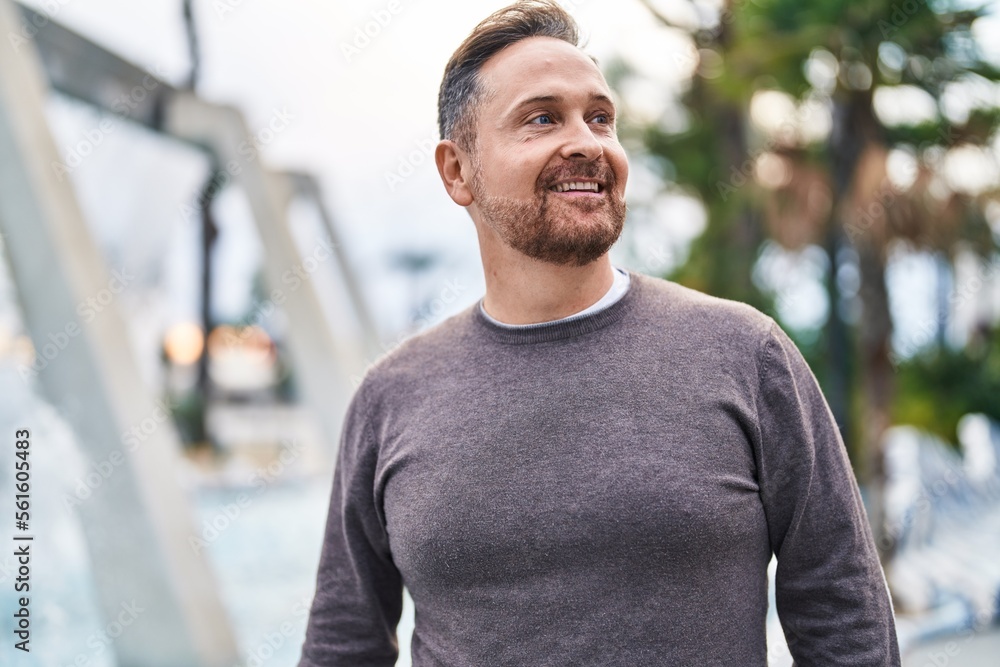 Young caucasian man smiling confident looking to the side at park