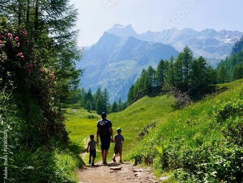 Father and his sons hiking in Alpe Devero, Parco Naturale Veglia-Devero, Val d'Ossola, Italy.
