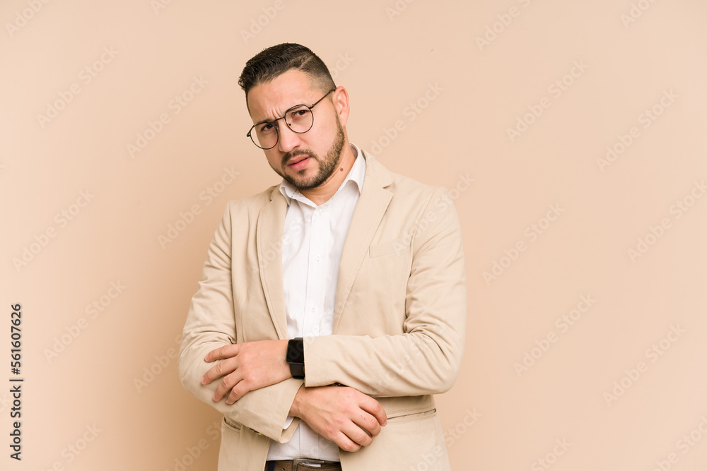 Adult latin business man cut out isolated unhappy looking in camera with sarcastic expression.