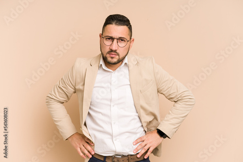 Adult latin business man cut out isolated confused, feels doubtful and unsure. photo