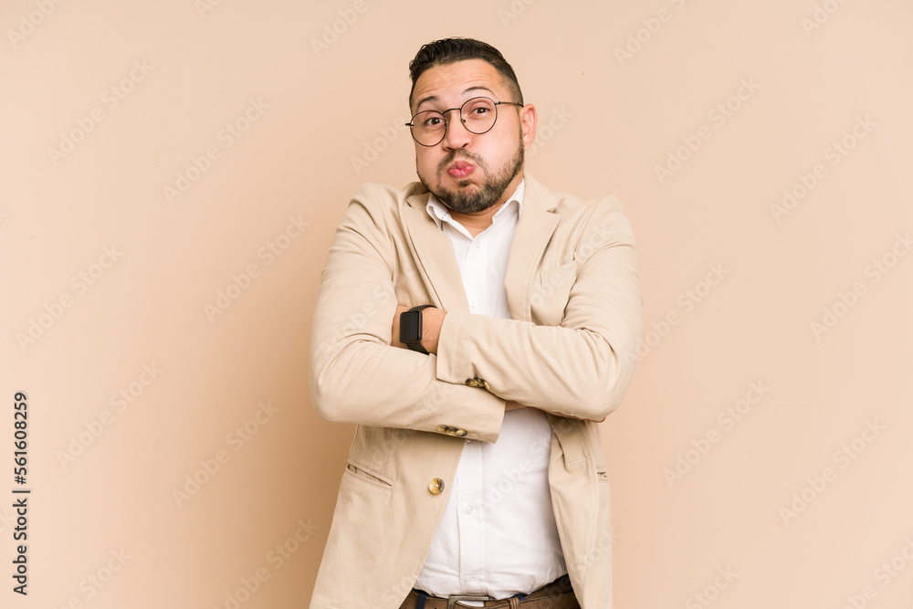 Adult latin business man cut out isolated blows cheeks, has tired expression. Facial expression concept. Adult latin business man cut out isolated blows cheeks, has tired expression. Facial expression concept.