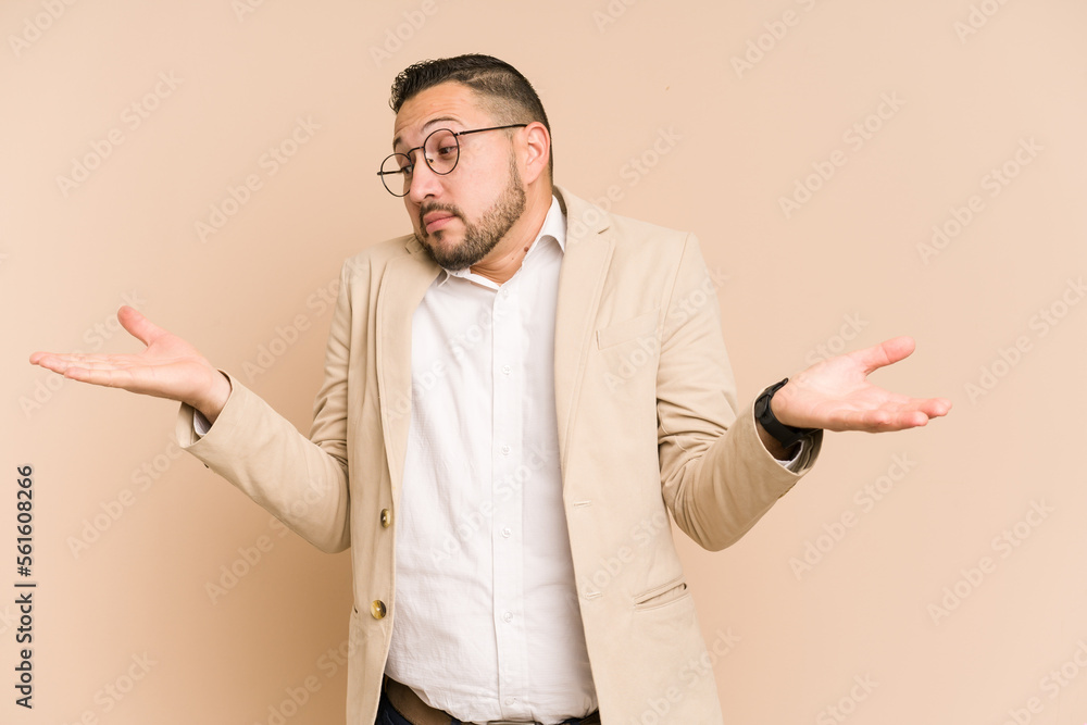 Adult latin business man cut out isolated confused and doubtful shrugging shoulders to hold a copy space. Adult latin business man cut out isolated confused and doubtful shrugging shoulders to hold a copy space.