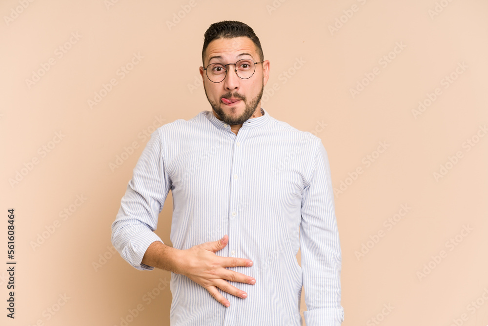 Adult latin man cut out isolated touches tummy, smiles gently, eating and satisfaction concept. Adult latin man cut out isolated touches tummy, smiles gently, eating and satisfaction concept.