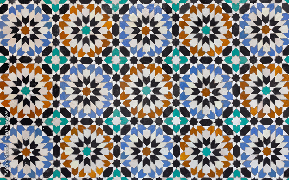 textures of ancient moroccan ceramic mosaic with geometric and floral pattern.