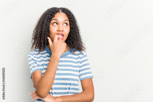 Young african american woman isolated on white background looking sideways with doubtful and skeptical expression.