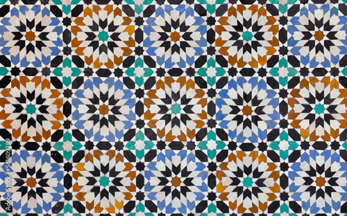 textures of ancient moroccan ceramic mosaic with geometric and floral pattern.