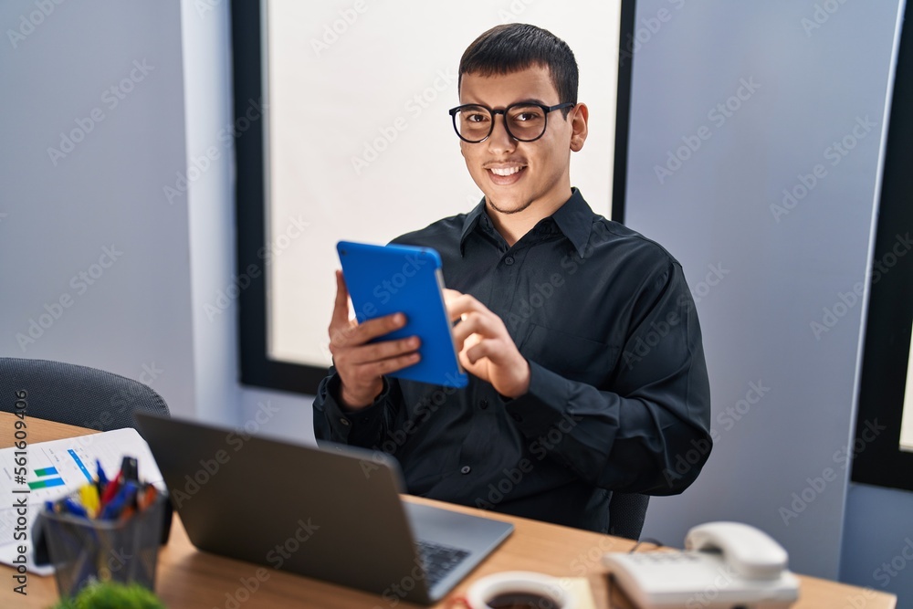 Young man business worker using laptop and touchpad at office Young man business worker using laptop and touchpad at office