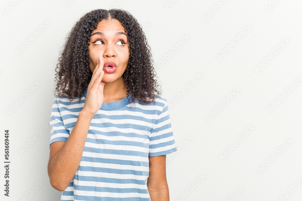 Young african american woman isolated on white background is saying a secret hot braking news and looking aside Young african american woman isolated on white background is saying a secret hot braking news and looking aside