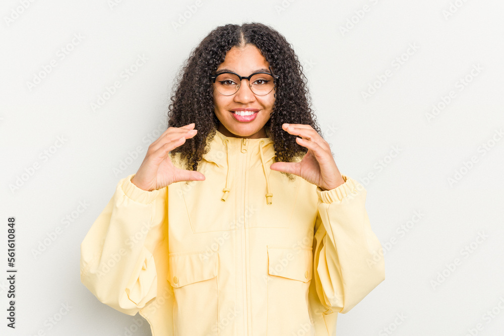 Young african american woman isolated on white background holding something with palms, offering to camera. Young african american woman isolated on white background holding something with palms, offering to camera.