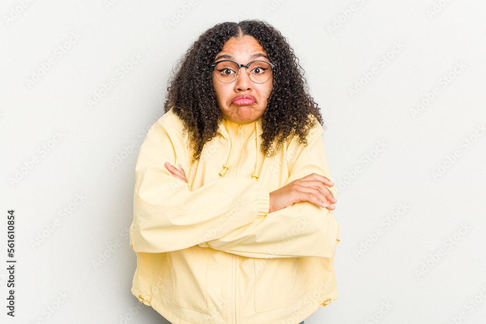 Young african american woman isolated on white background shrugs shoulders and open eyes confused. Young african american woman isolated on white background shrugs shoulders and open eyes confused.